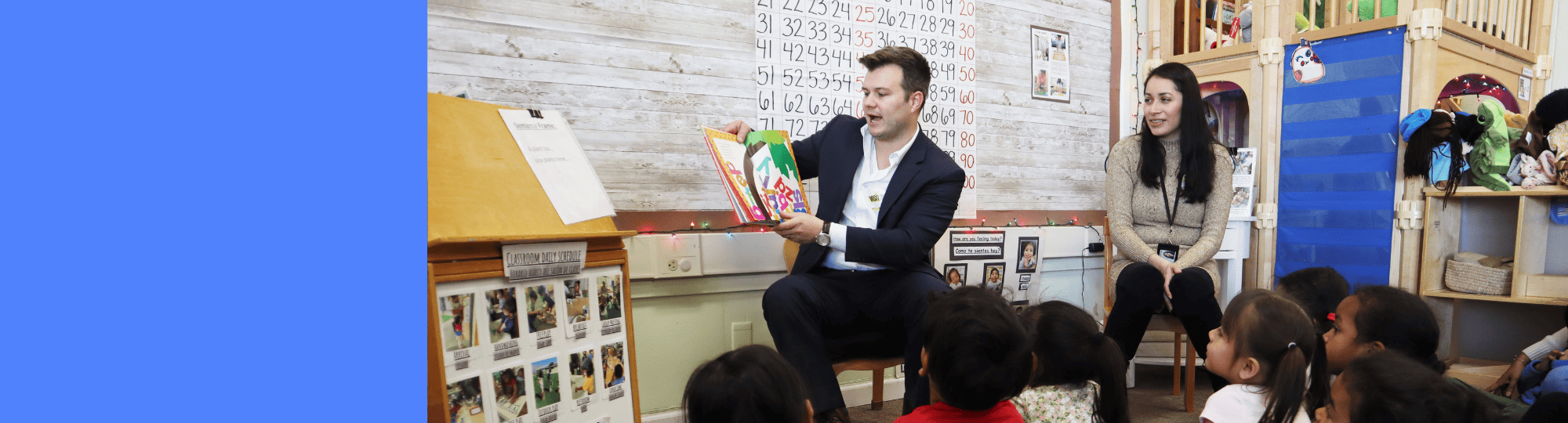 Two ELS members reading to a classroom