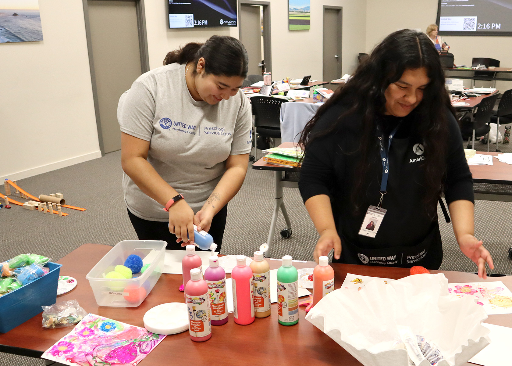 Two Preschool Service Corps members playing with paint