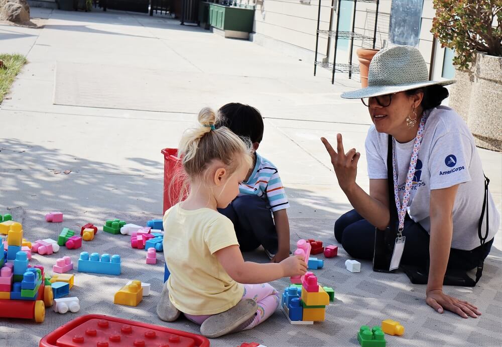 PSC Volunteer building with legos with a student