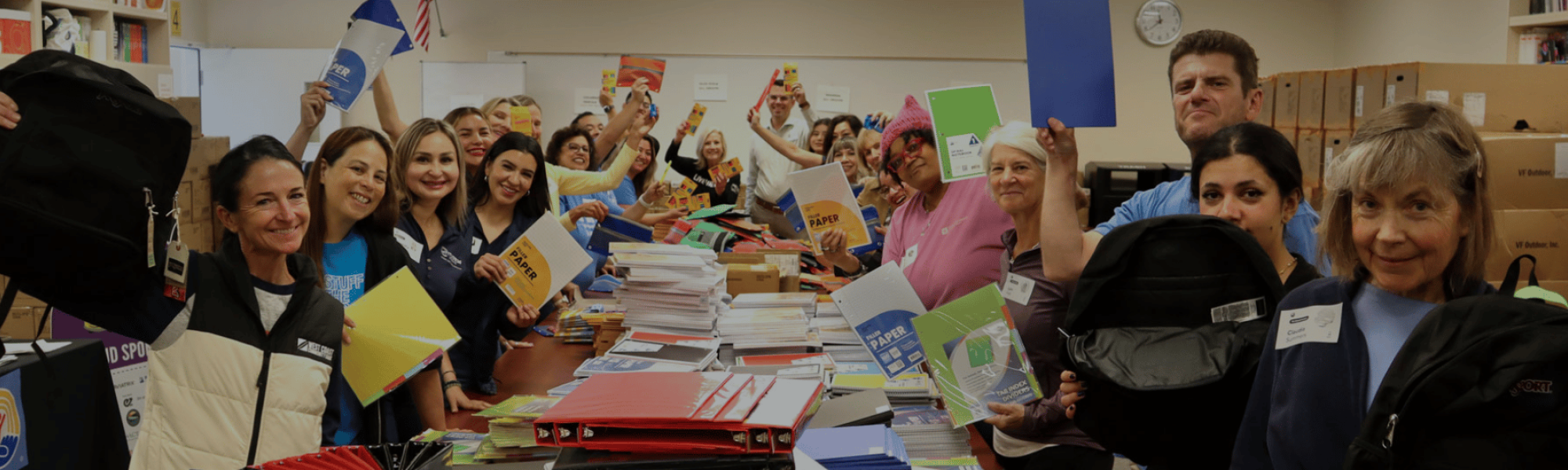 vOLUNTEERS HOLDING UP SUPPLIES